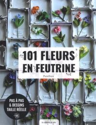 Couverture du livre "101 fleurs en feutrine" de PieniSieni publié aux Éditions de Saxe. Le visuel original met en scène une multitude de délicates fleurs colorées en feutrine, minutieusement disposées dans de petites boîtes rectangulaires à la manière d'u